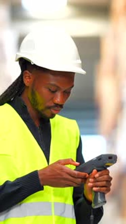 Logistics Operator Scanning Packages in Warehouse