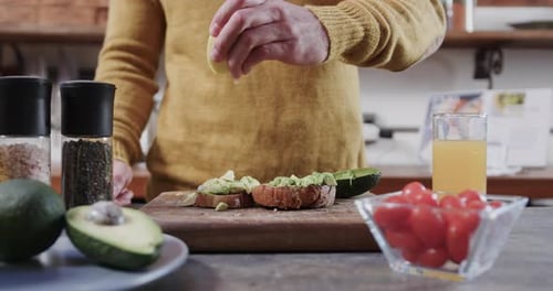Squeezing Lemon on Avocado Toast in Kitchen