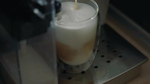 Close Up of Coffee Pouring into Milk