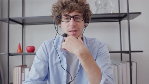 Young Adult Man Wearing Headset in Video Call