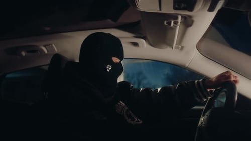 Figure in Balaclava Drives Car at Night