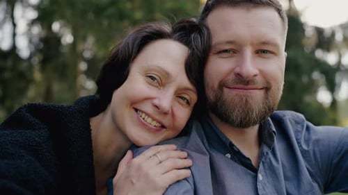 Loving Couple Enjoying a Warm Embrace in a Serene Park Setting