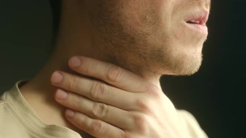 Young Man Touching Sore Throat, Close Up