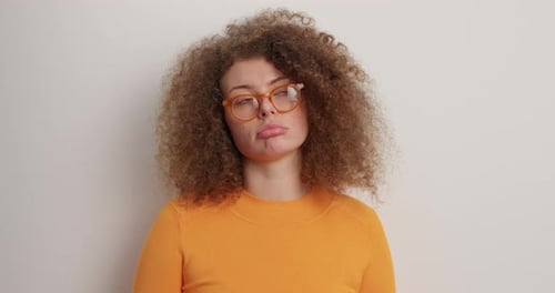 Sad Tired Woman Looks With Poker Face At Camera Purses Lower Lip Being Offended Has Frustrated Ex...