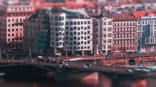 Busy traffic on the crossroad in front of the Dancing House on the Jiraskove square, Prague. Cars, t