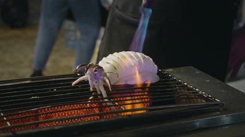 Cooking Squid on a Grill with a Torch to Create a Delicious Seafood Dish
