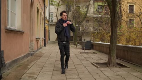 Man sightseeing in a historic European city on a cold winter day