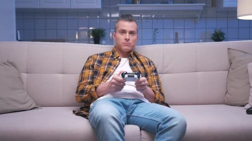 Man on Couch Playing Video Game Controller