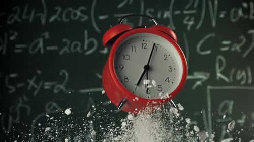 Alarm Clock Flies with School Chalk Against the Background of the Blackboard Filmed on a Highspeed