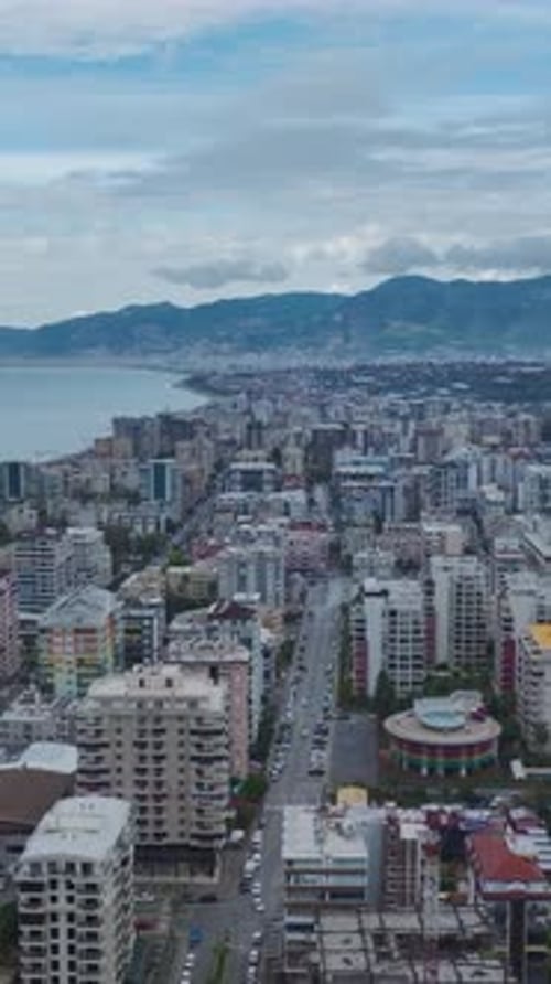 Vertical Video Aerial View of a Construction Site With Workers Engaged in Varied Activities and