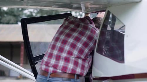 Professional Pilot Taking Seat Cabin White Private Airplane on Aerodrome. Man Aviator