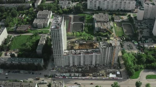 Residential complex under construction in city in summer. Stock footage. Districts of city