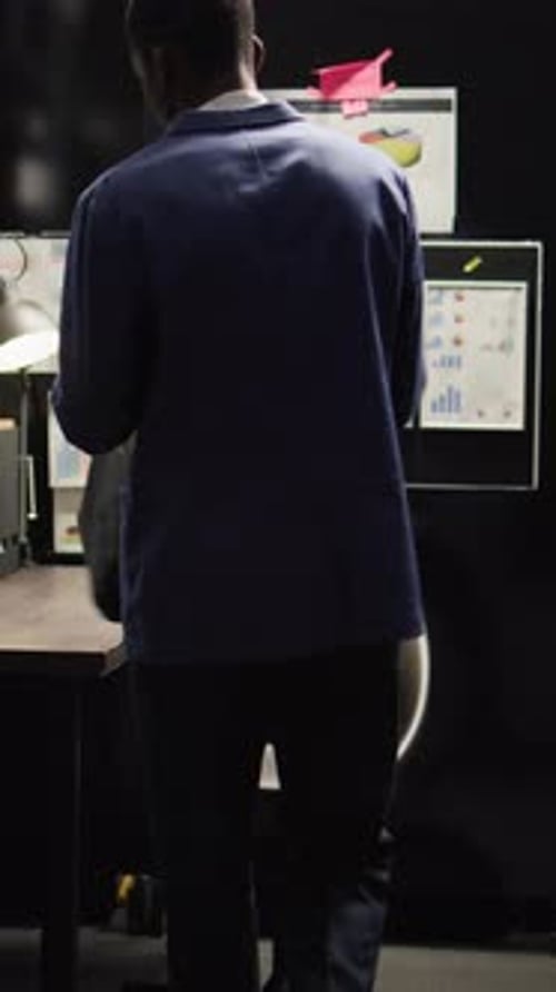 Employee Working on Laptop in Dark Office