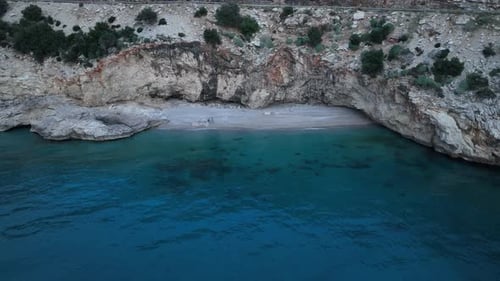 Atmospheric sunset scene on a peaceful beach with warm colors reflecting on the water