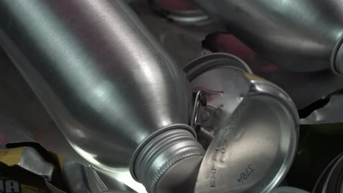 New Aluminum Bottles and Used Drink Cans, Metal Recycling Concept, Close Up