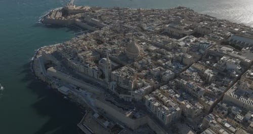 Aerial view of historic cityscape and coastline by the Mediterranean Sea, Malta.
