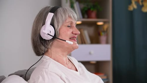 Senior Woman Wearing Headset Talking Indoors