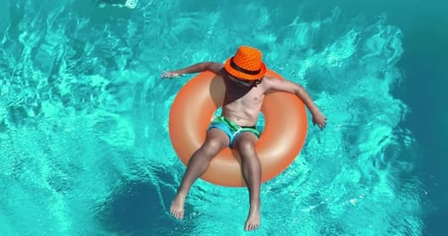 Kid Floating in Pool