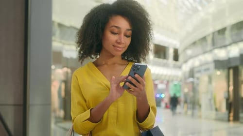 African American Woman Holding Mobile Phone Smartphone Cellphone Shopping Mall Texting Sms Chat