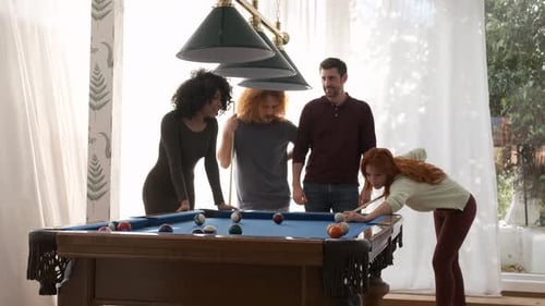 Friends Watching Woman Playing Pool in Game Room