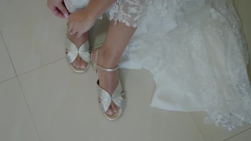 Bride Attaches Straps on Decorative Metallic Shoes