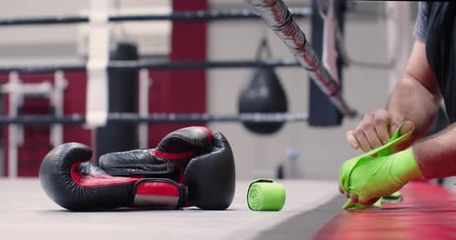 Man Wrapping Hands in Boxing Gym Before Workout