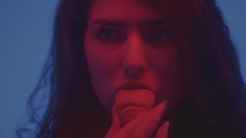 Portrait of an Attractive Young Girl Eating a Croissant in the Studio