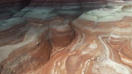 Aerial View of Lonely Woman Walking Uphill in Moonlike Desert Landscape of Utah USA, Drone Shot