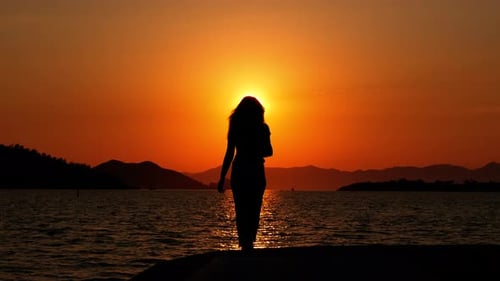 Woman Silhouette Watching Ocean Sunset on Pier
