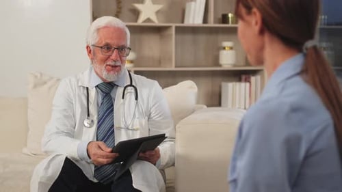 Senior Man Doctor Examining Young Woman in Doctor Office Clinic or at Home Girl Patient and Doctor