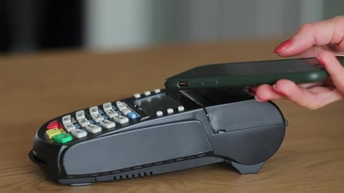 Close Up Woman Customer Pays with Contactless Nfc Payment Technology on Smartphone to Friendly