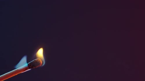 Match Igniting and Burning Brightly in the Dark