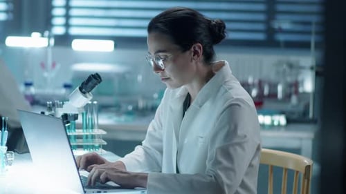 Female Scientist Working on Laptop in Bright Laboratory