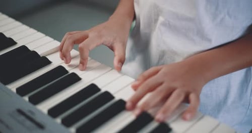 Close-up hand of Creative asian boy with artistic skills taking music lessons online
