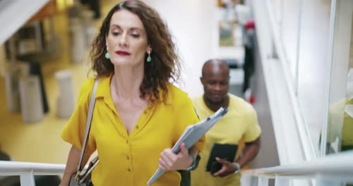Business People Walking Up Office Staircase