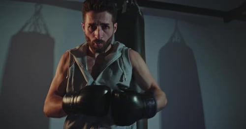 Man Boxing with Fierce Determination in Gym