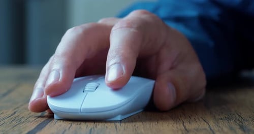 Man's Hand Actively Uses a Computer Mouse While Working at a Computer Clicks and Scrolls Online Web