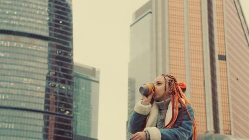 Stylish Woman Drinking Coffee in Urban Setting