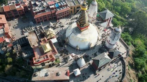 Aerial view over Swayambhunath temple, ancient buddhist shrine, with prayer flags moving in the wind