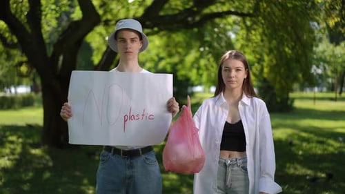 Young Couple Protests Against Plastic in Sunny Park