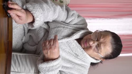 Elderly Woman Testing Blood Sugar at Home
