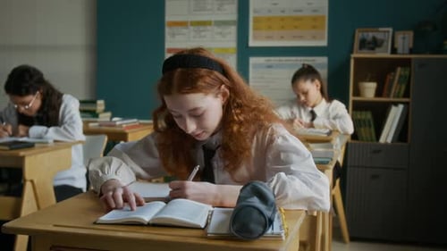 Students Studying and Writing in a Classroom