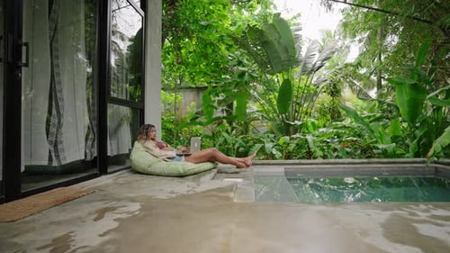 Multiethnic Woman Relaxes By Poolside with Laptop Enjoys Serene Tropical Setting Freelancer Works