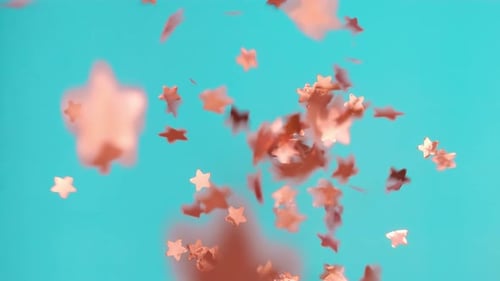 Pink Paper Stars Fall in Blue Studio Scattered on Surface
