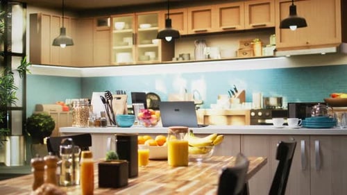 Well-Lit Kitchen with Fruit, Juice, and Laptop