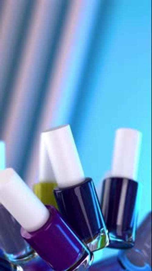 Colorful Nail Polish Bottles Rotating on Blue Background