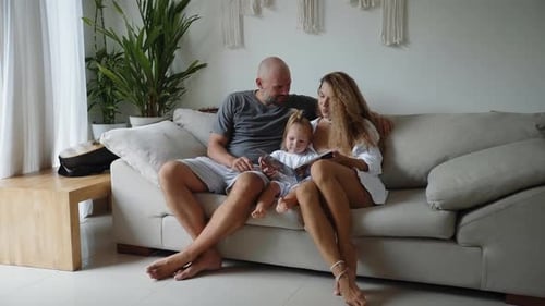 Family Togetherness Looking at Photo Album at Home