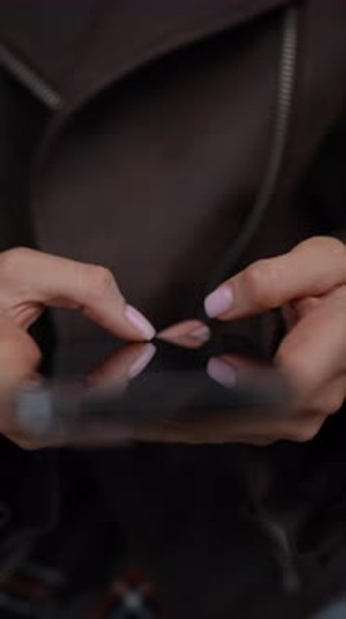 Vertical Top View of Female Hands Holding Smartphone Typing on Screen Using Mobile Applications