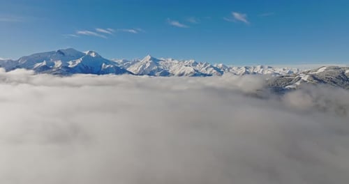 Majestic Snowy Mountains Behind Sea Of Clouds