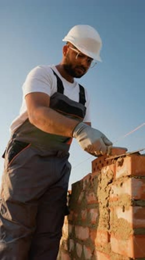 Indian Builder Carefully Constructs a Residential Wall